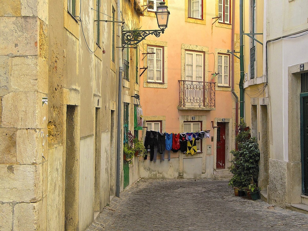 Enge Gasse mit bunter Wäsche zwischen den Häusern der Lissabonner Altstadt